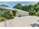 Three-car garage with attached screened porch at 1101 Anclote Blvd, Tarpon Springs, FL 34689
