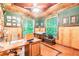 Bright home office features built-in shelving and wood-paneled walls at 1101 Anclote Blvd, Tarpon Springs, FL 34689