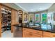 Well-stocked pantry and kitchen with custom wood cabinets at 1101 Anclote Blvd, Tarpon Springs, FL 34689