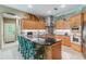Modern kitchen with light wood cabinets and granite island at 1101 Anclote Blvd, Tarpon Springs, FL 34689
