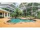 Inviting freeform pool with waterfall feature and screened enclosure at 1101 Anclote Blvd, Tarpon Springs, FL 34689