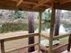 Wooden porch overlooking a tranquil pond and lush greenery at 1101 Anclote Blvd, Tarpon Springs, FL 34689