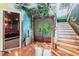 Grand staircase with unique mural and home theater view at 1101 Anclote Blvd, Tarpon Springs, FL 34689