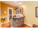 Wet bar with stone countertop and wine storage at 1101 Anclote Blvd, Tarpon Springs, FL 34689