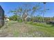 Backyard with grass and large tree at 1110 Beachcomber Ct # 1, Osprey, FL 34229