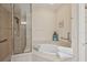 Bathroom with a large soaking tub and walk-in shower at 1110 Beachcomber Ct # 1, Osprey, FL 34229
