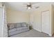 Bedroom with grey sofa and ceiling fan at 1110 Beachcomber Ct # 1, Osprey, FL 34229