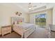 Bright bedroom with a king-size bed and sliding glass doors at 1110 Beachcomber Ct # 1, Osprey, FL 34229