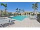 Community pool with lounge chairs and patio at 1110 Beachcomber Ct # 1, Osprey, FL 34229