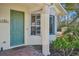Quaint entryway with a green door and bay window at 1110 Beachcomber Ct # 1, Osprey, FL 34229