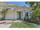 Two-story house with light yellow walls, green door, and a two-car garage at 1110 Beachcomber Ct # 1, Osprey, FL 34229