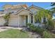 Two-story house with light yellow walls, green door, and a two-car garage at 1110 Beachcomber Ct # 1, Osprey, FL 34229
