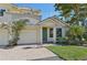 Two-story house with light yellow walls, green door, and a two-car garage at 1110 Beachcomber Ct # 1, Osprey, FL 34229