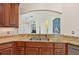 Kitchen with granite countertops and double sink at 1110 Beachcomber Ct # 1, Osprey, FL 34229