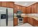 Kitchen features stainless steel appliances and wood cabinetry at 1110 Beachcomber Ct # 1, Osprey, FL 34229