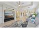 Open living space with large TV, seating area, and access to kitchen at 1110 Beachcomber Ct # 1, Osprey, FL 34229