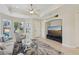 Living room with large TV, comfy seating, and access to other rooms at 1110 Beachcomber Ct # 1, Osprey, FL 34229