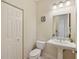 Small half bathroom with pedestal sink and toilet at 1110 Beachcomber Ct # 1, Osprey, FL 34229