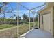 Screened porch with view of backyard and street at 1110 Beachcomber Ct # 1, Osprey, FL 34229