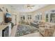 Relaxing sunroom with large windows, seating area, and wet bar at 1110 Beachcomber Ct # 1, Osprey, FL 34229
