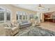Bright sunroom features comfortable seating and views to the kitchen at 1110 Beachcomber Ct # 1, Osprey, FL 34229