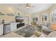 Bright sunroom with large windows, seating area, wet bar, and TV at 1110 Beachcomber Ct # 1, Osprey, FL 34229