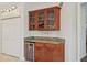 Built-in wet bar with wine rack and mini-refrigerator at 1110 Beachcomber Ct # 1, Osprey, FL 34229