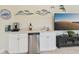 Convenient wet bar with a mini-fridge and coffee station at 1110 Beachcomber Ct # 1, Osprey, FL 34229