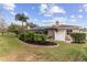 Well-manicured backyard featuring a screened patio and lush landscaping at 11921 Whistling Way, Lakewood Ranch, FL 34202