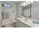 Clean bathroom with white vanity and shower/tub combo at 11921 Whistling Way, Lakewood Ranch, FL 34202