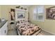 Guest bedroom with a Murphy bed, cow print bedding, and window shutters at 11921 Whistling Way, Lakewood Ranch, FL 34202