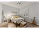 Bright bedroom with a queen bed, wood floors, and window shutters at 11921 Whistling Way, Lakewood Ranch, FL 34202