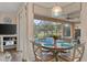 Bright breakfast nook with pool view, seating for four at 11921 Whistling Way, Lakewood Ranch, FL 34202