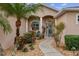 Welcoming front entry with a walkway, landscaping, and a teal door at 11921 Whistling Way, Lakewood Ranch, FL 34202