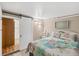 Bedroom with a queen bed, barn door to en-suite bathroom at 1210 41St Avenue E Dr, Ellenton, FL 34222
