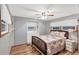 Bedroom with a double bed, ceiling fan, and light wood floors at 1210 41St Avenue E Dr, Ellenton, FL 34222