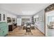 Bright dining area with glass table and chairs, hardwood floors, and a view into the living room at 1210 41St Avenue E Dr, Ellenton, FL 34222