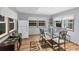 Dining area features hardwood floors, glass table with chairs, and white appliances at 1210 41St Avenue E Dr, Ellenton, FL 34222