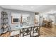 Glass dining table with chairs and hardwood floors, open to living room at 1210 41St Avenue E Dr, Ellenton, FL 34222