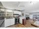 Open kitchen with stainless steel appliances and wood flooring at 1210 41St Avenue E Dr, Ellenton, FL 34222