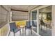 Covered porch with two chairs and sliding glass door access at 1210 41St Avenue E Dr, Ellenton, FL 34222