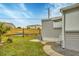 Landscaped side yard with grassy area and walkway at 1210 41St Avenue E Dr, Ellenton, FL 34222