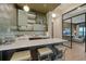 Modern bar with quartz countertops and glass-front cabinetry at 1210 Blue Shell Loop, Sarasota, FL 34240