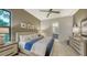 Comfortable bedroom with ceiling fan and ensuite bathroom access at 1210 Blue Shell Loop, Sarasota, FL 34240