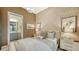 Cozy bedroom with ensuite bathroom and patterned wallpaper at 1210 Blue Shell Loop, Sarasota, FL 34240
