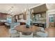 Modern dining room with round table and chairs, adjacent to kitchen at 1210 Blue Shell Loop, Sarasota, FL 34240