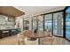 Modern dining room with round table, chandelier, and access to pool area at 1210 Blue Shell Loop, Sarasota, FL 34240
