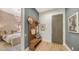 Bright entryway with built-in bench, coat rack, and view to bedroom at 1210 Blue Shell Loop, Sarasota, FL 34240