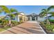 Two-story home with brick driveway and landscaping at 1210 Blue Shell Loop, Sarasota, FL 34240