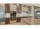 Modern kitchen with double ovens, ample cabinetry, and expansive island at 1210 Blue Shell Loop, Sarasota, FL 34240